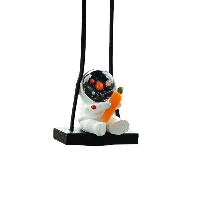 Resin astronaut car pendant showing five colour options including telescope and red flag designs