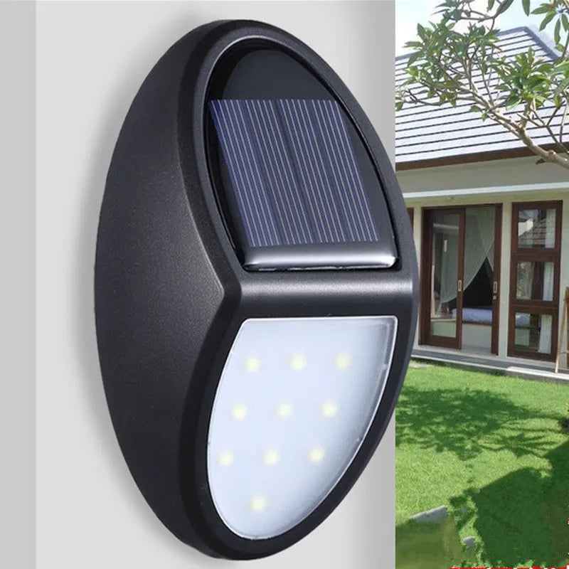 Black rectangular solar-powered LED wall light with solar panel on top.