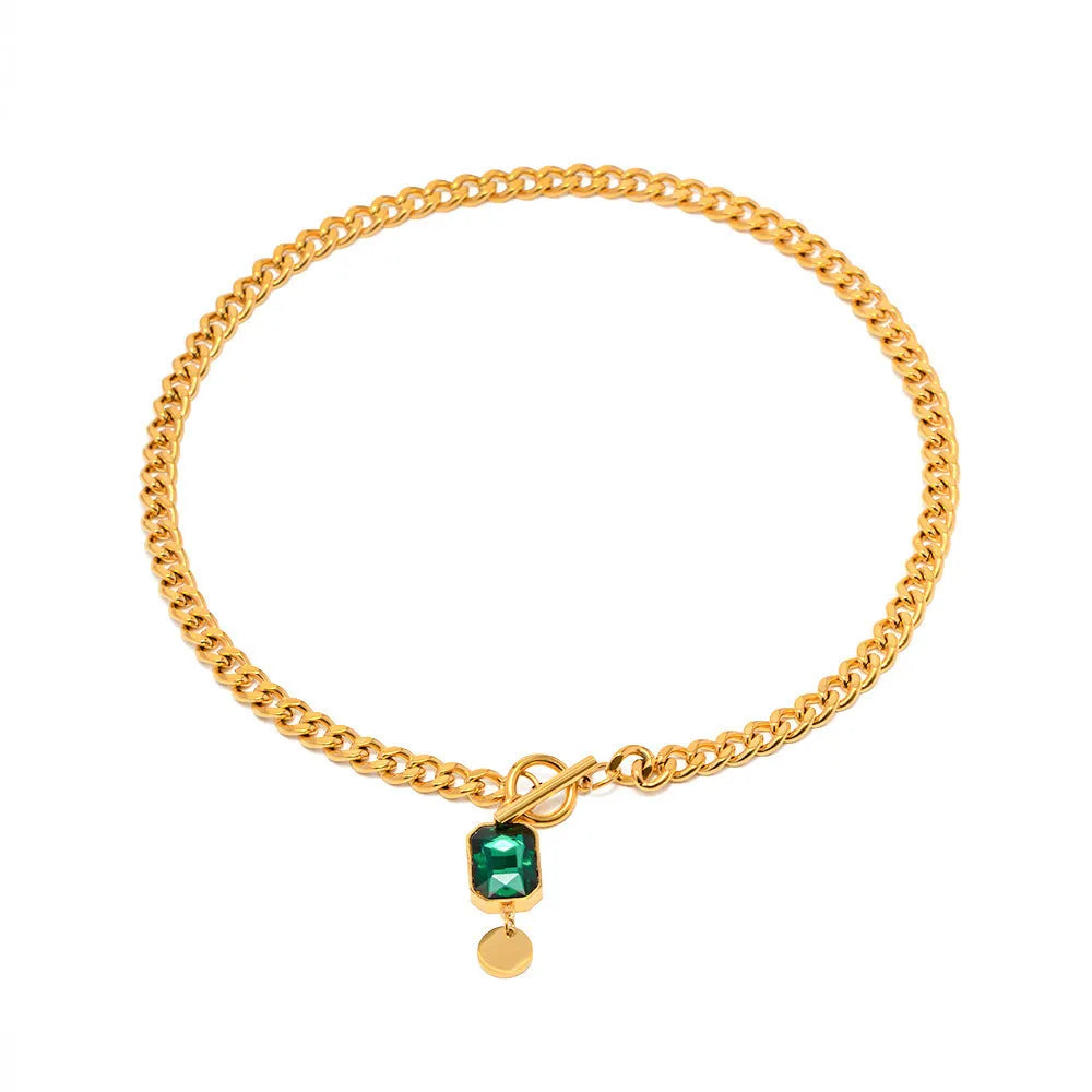 Gold electroplated titanium steel necklace with emerald zircon geometric pendant on Cuban link chain