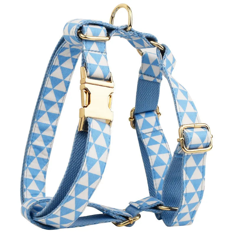 Blue cloth dog collar, leash, vest, and bow set arranged together showing all four pieces.