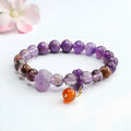 Close-up of a nine purple Fire Duobao and amethyst crystal bracelet with red agate stones, Mori style.