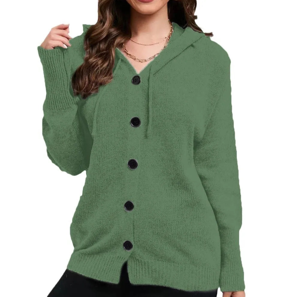 Woman wearing a thick, loose-fit hooded cardigan sweater in a solid colour with a 3D textured pattern.