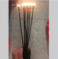 Solar-powered LED garden light with multiple heads on a metal spike in grass.