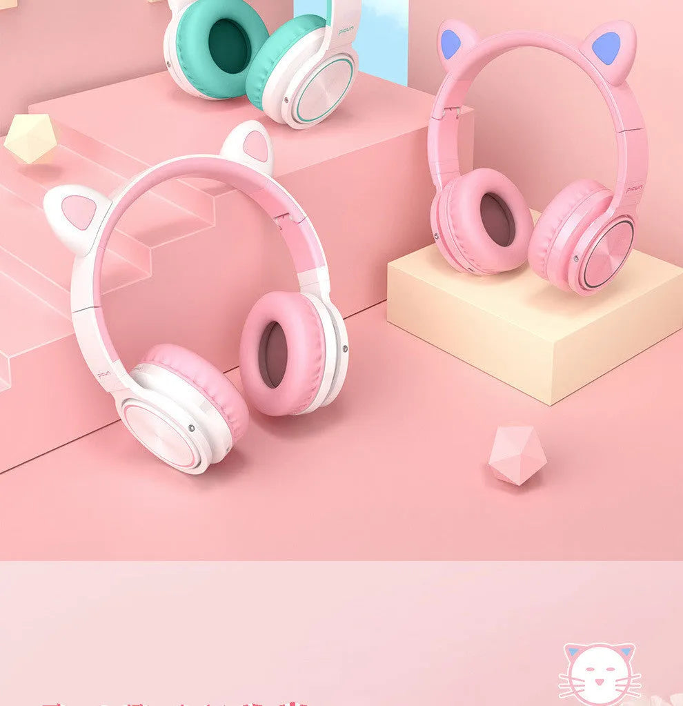 Pink and white wireless Bluetooth over-ear headphones with protein ear cushions and braided charging cable