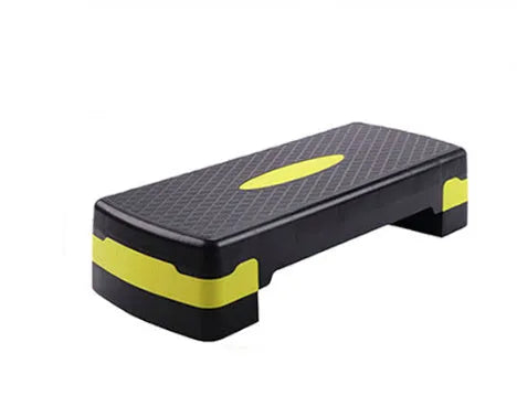 Grey fit step aerobics platform made of ABS plastic on a wooden floor.