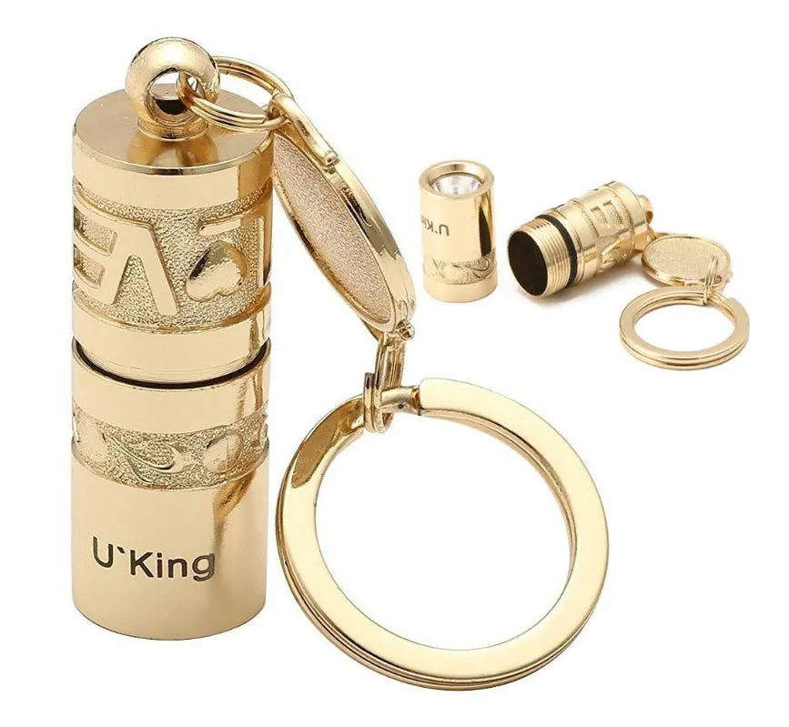 Gold-coloured waterproof zinc alloy portable LED flashlight on a keychain ring.