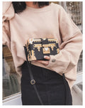 Women's black hard PU leather shoulder bag with single strap and decorative rivet detailing