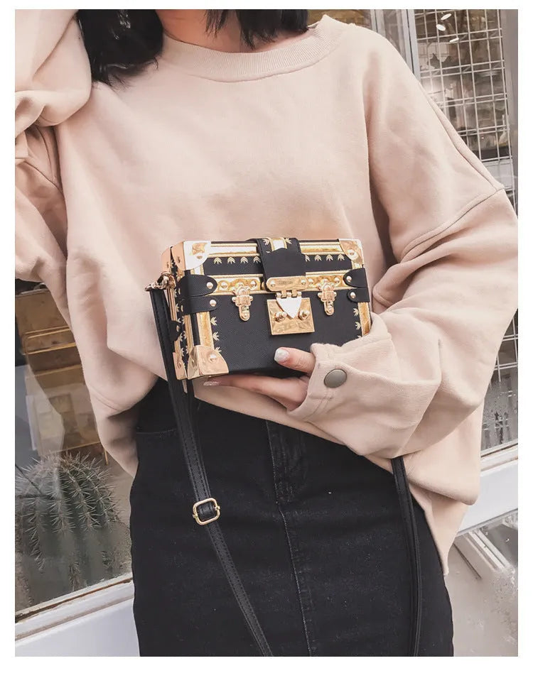 Women's black hard PU leather shoulder bag with single strap and decorative rivet detailing