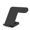 Black and white wireless phone charging pad on a desk with a Type-C cable