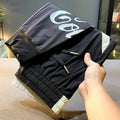 Black ultra-thin ice silk ankle banded cropped trousers for men displayed flat
