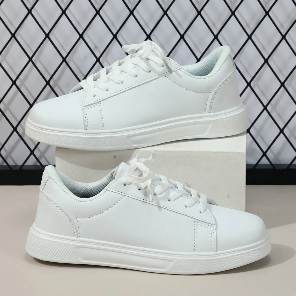 Women's platform skateboard sneakers with cross-strap detailing and mid-heel sole