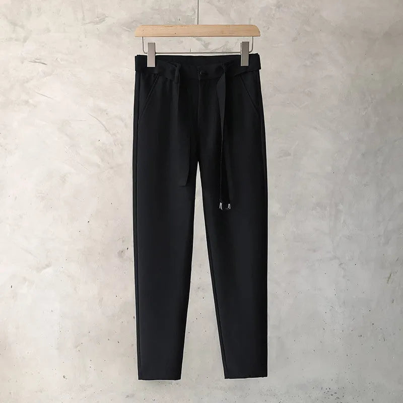 Boys slim straight trousers in wool blend fabric on a hanger, showing tapered leg
