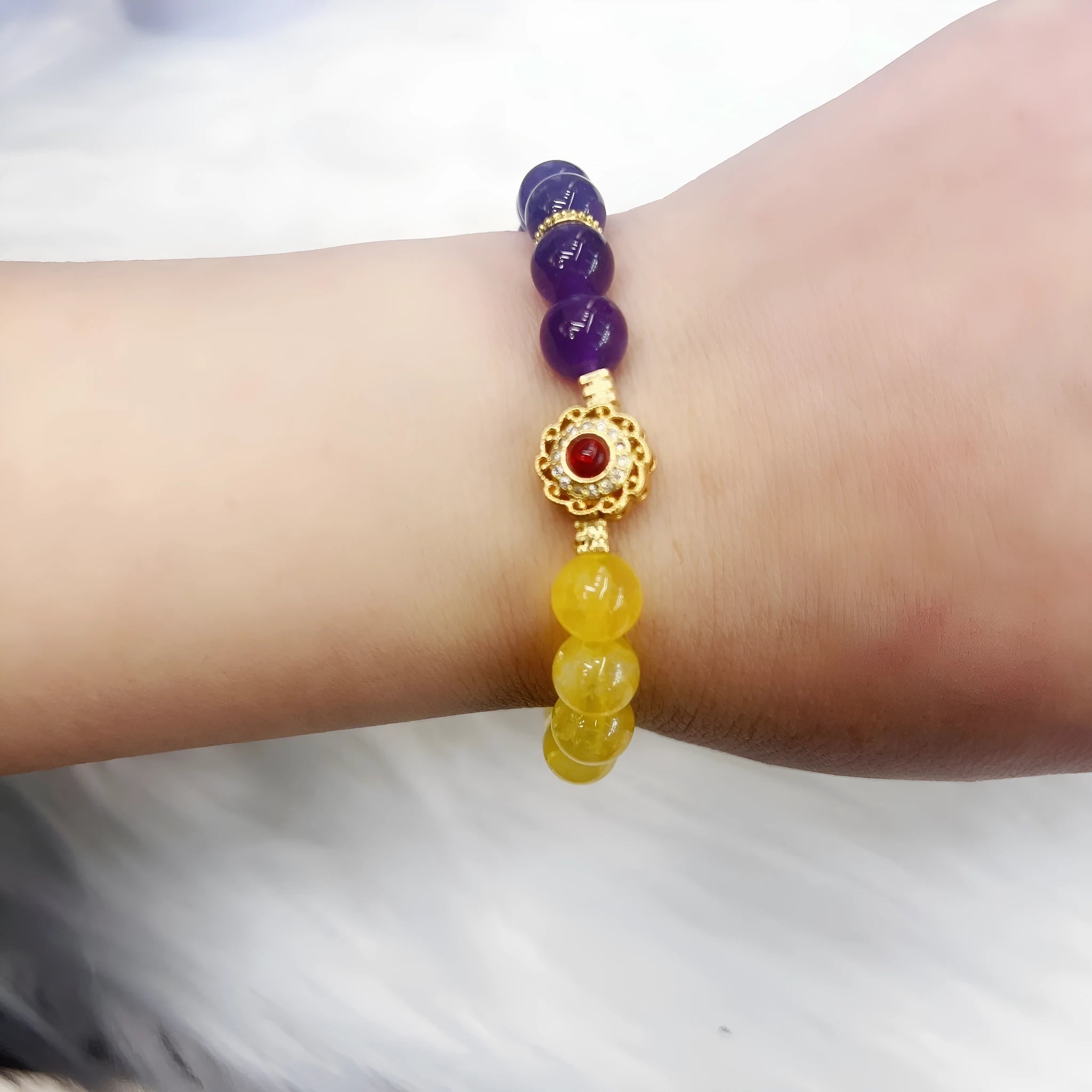 Handmade women's yellow and purple amethyst crystal bracelet with handcrafted details