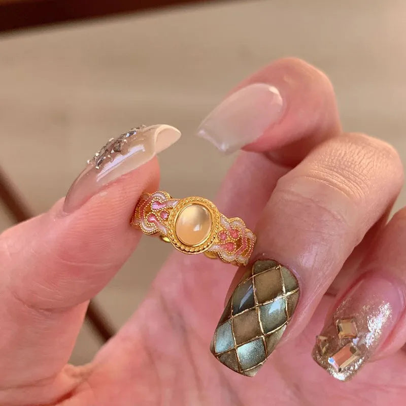 Open geometric ring with pink crystal enamel decoration and gold-plated finish, adjustable design