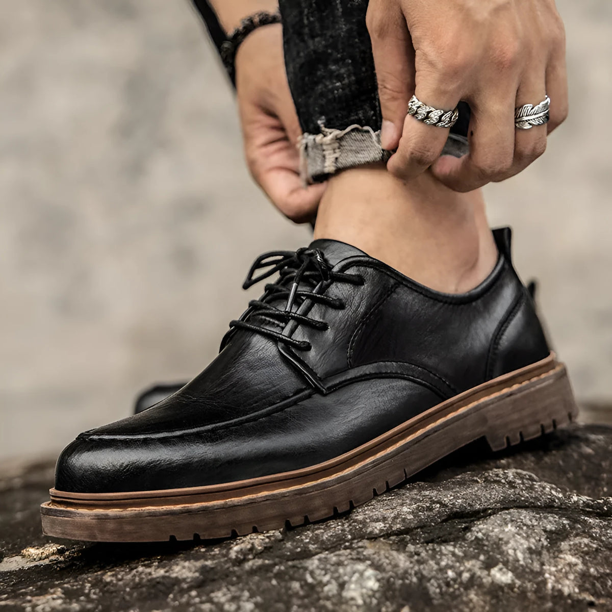 Men's black and brown casual leather shoes with a round toe and flat rubber sole.