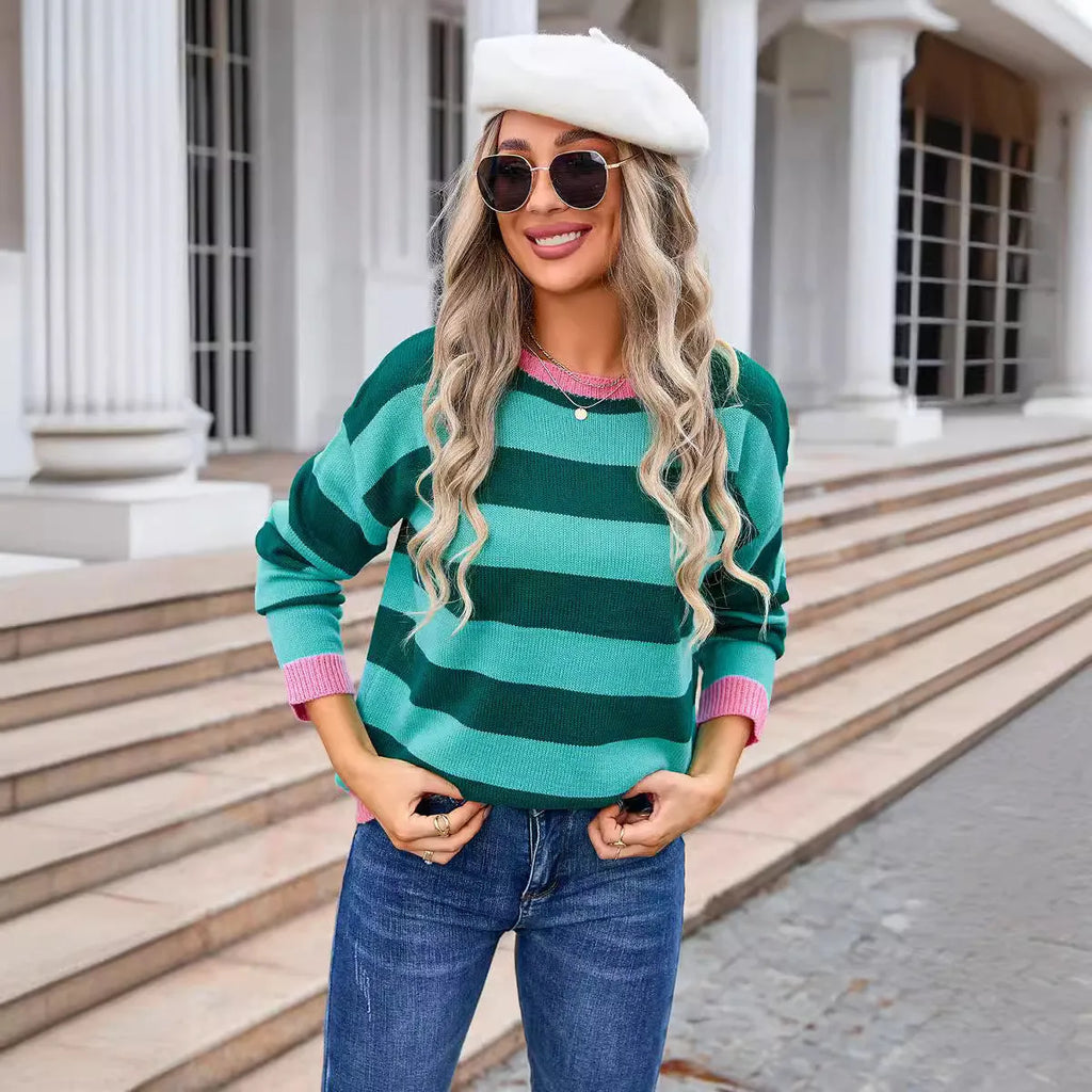 Women's loose fit long sleeve acrylic sweater in blue, showing round neck and stripe detail.