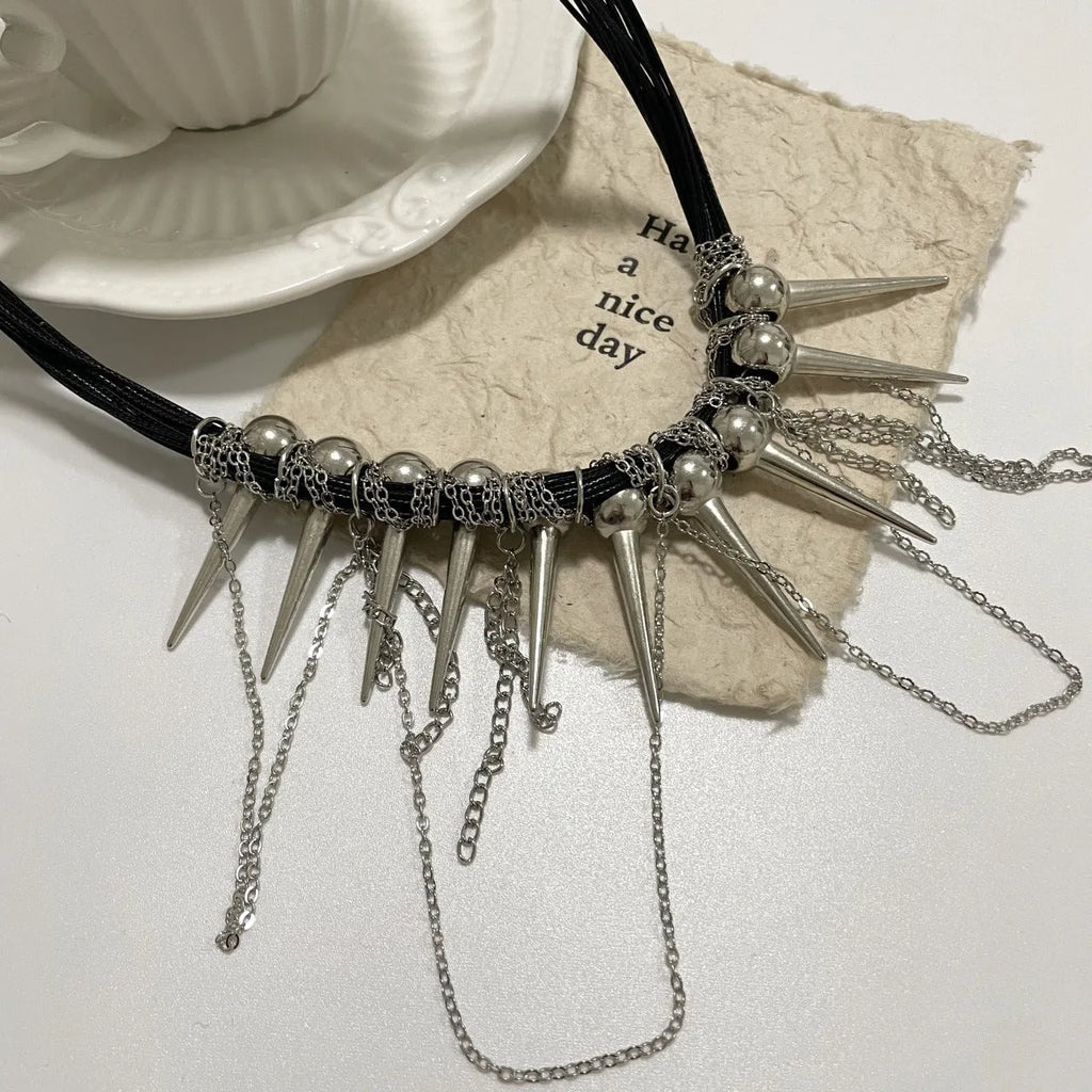 Leather necklace with round beads and winding tassel design featuring point rivet details