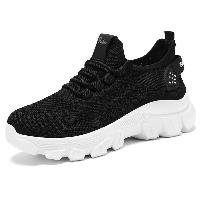 Women's white Flyknit sneaker with thick PVC sole and lace-up closure on a neutral background.