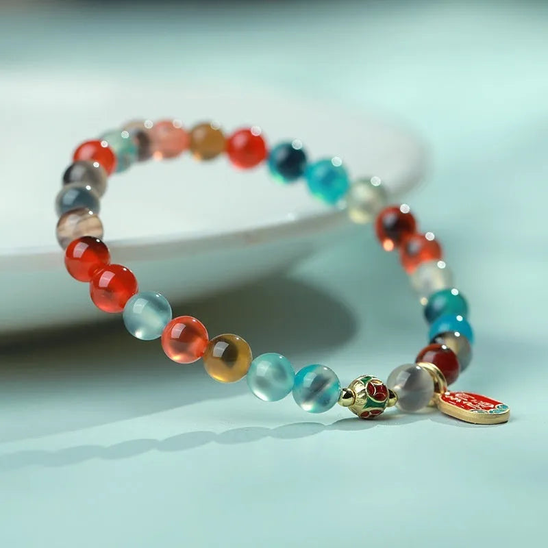 Women's agate snake bracelet with copper coin detailing and coloured glaze accents in geometric design