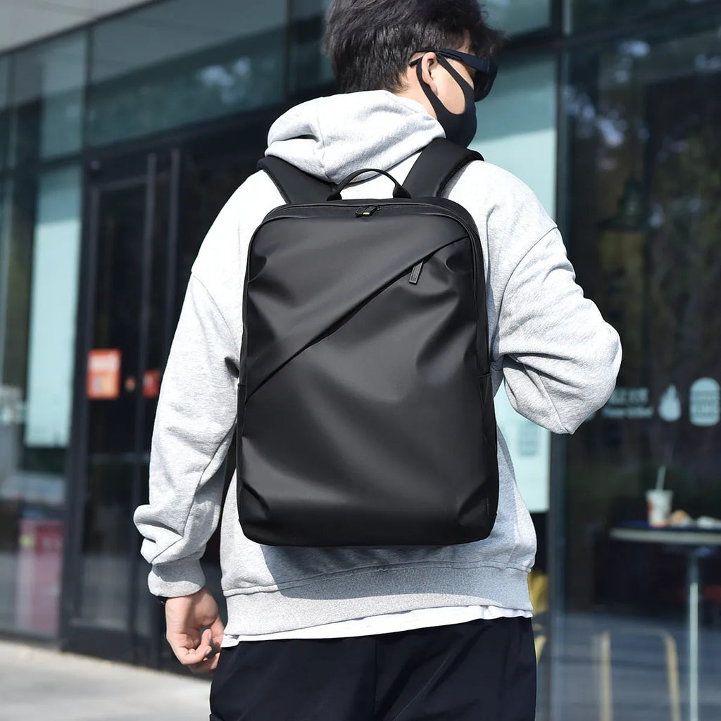 Large waterproof backpack in PU leather available in black, blue, or grey colours
