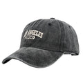 Retro style peaked cap with embroidered distressed letters on the front, shown in beige colour.