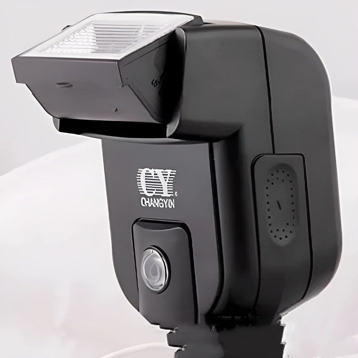 SLR camera flash accessory with tilted head shown on a hot shoe, displaying compact size.