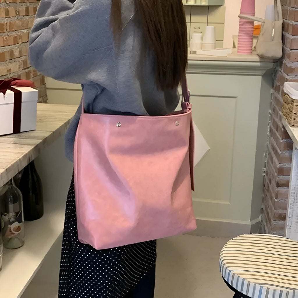 Corduroy commuter shoulder bag in pink colour with one-shoulder carry design