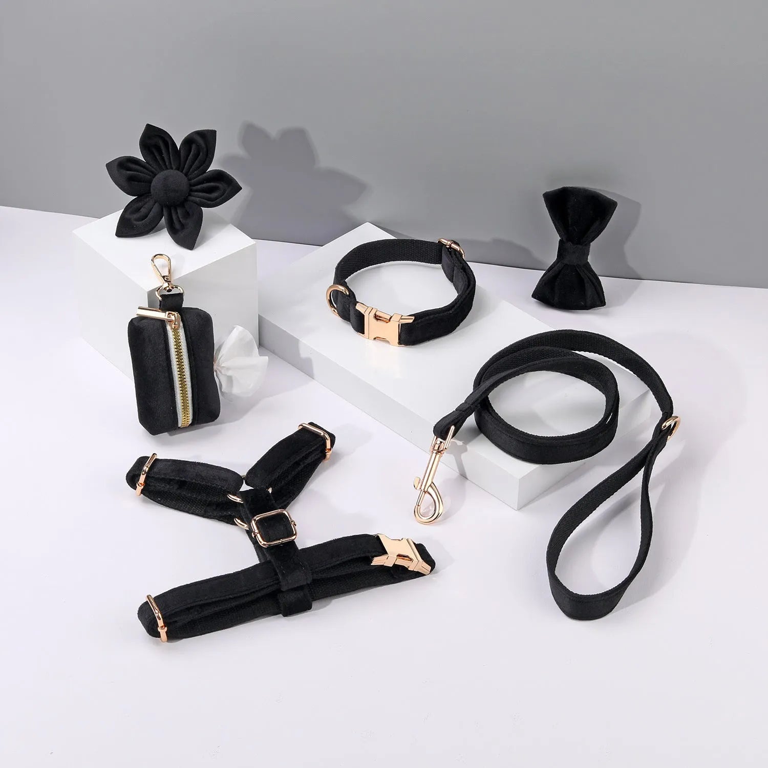 Complete velvet dog collar and traction rope set with bow tie, flower, and toilet bag on a table