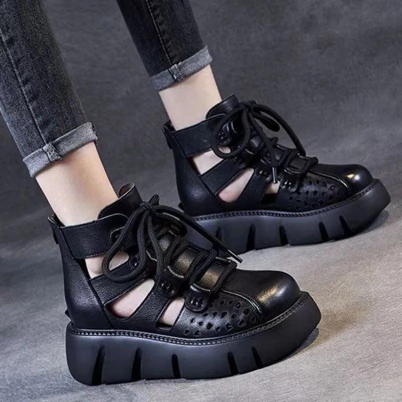 Women's black platform sandals with hollow hole design and fish mouth toe, made from soft leather.