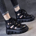 Women's black platform sandals with hollow hole design and fish mouth toe, made from soft leather.