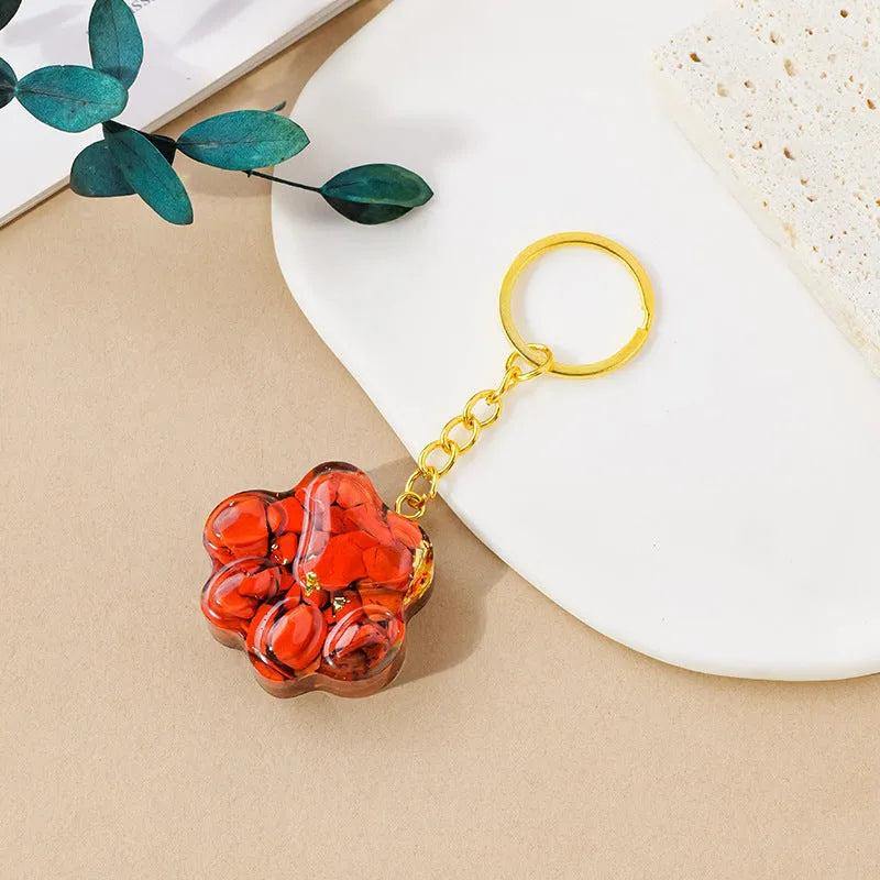 Small handcrafted crystal cat's paw shaped keychain pendant on a keyring.