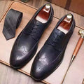 Men's pointed toe brogue formal shoes in black leather with carved patterns and low heel
