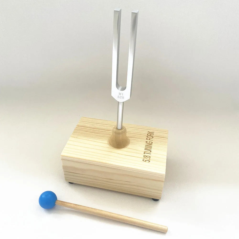 Aluminium alloy 432 Hz tuning fork with built-in speaker on kraft paper box.