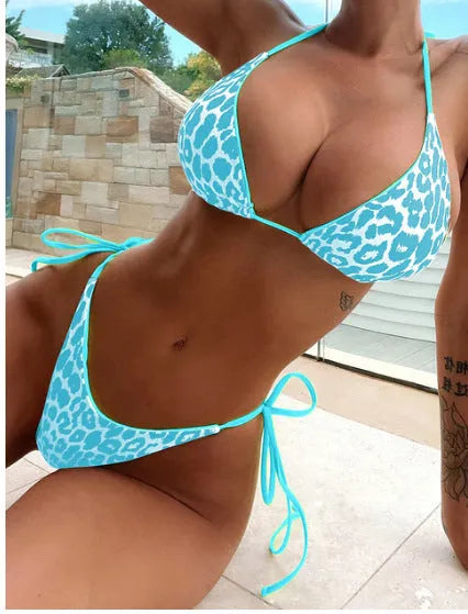 Women's lace-up front triangle bikini top with matching split skirt swim shorts.