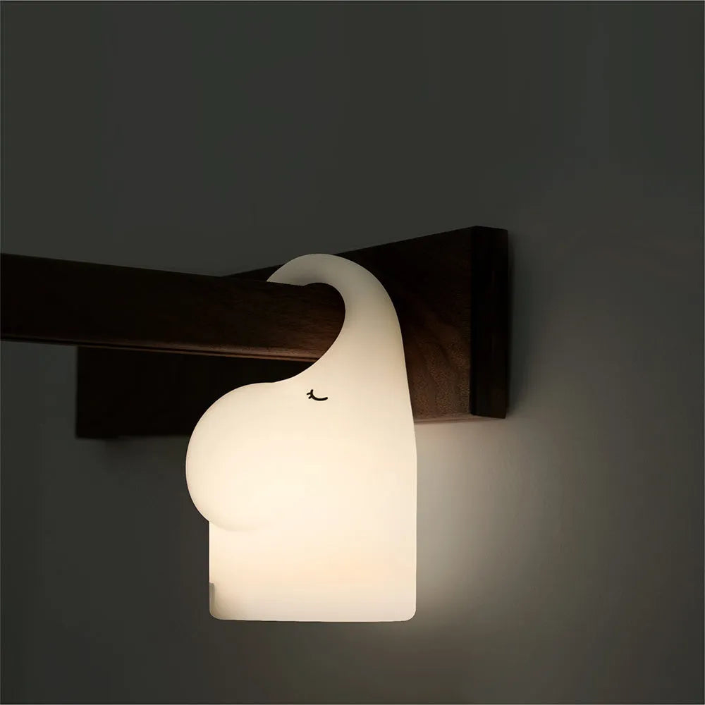 DOMI Elephant silicone night light with soft white LED glow on bedside table