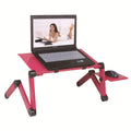 Black folding metal laptop desk with cooling fans and integrated mouse board extended on a carpet.