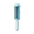 Blue pet hair remover roller with self-cleaning base on a carpet next to a dog.