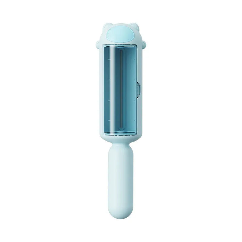 Blue pet hair remover roller with self-cleaning base on a carpet next to a dog.