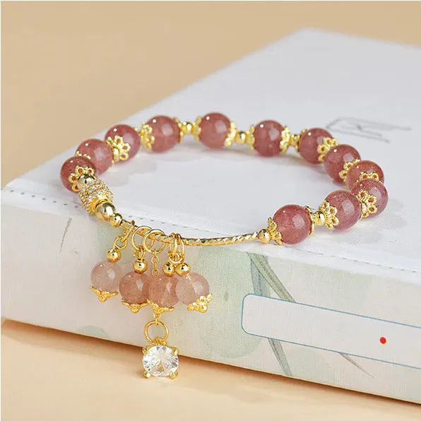 Pink women's crystal bracelet with heart-shaped charms and pearl decorative accents