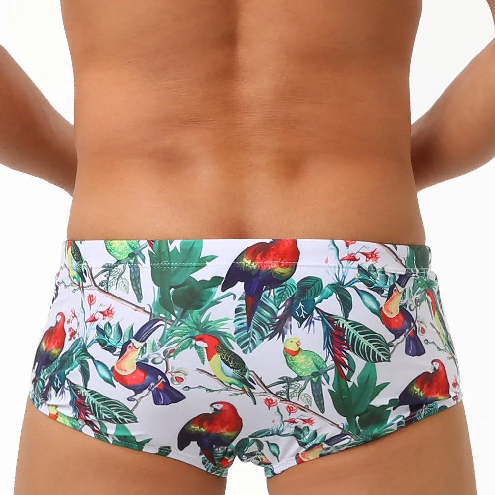 Men's floral bird print nylon swim trunks in boxer style on white background