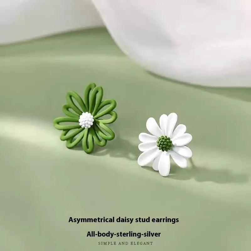 Close-up of cartoon-style flower stud earrings in alloy, shown in blue and orange two-tone colour combination.
