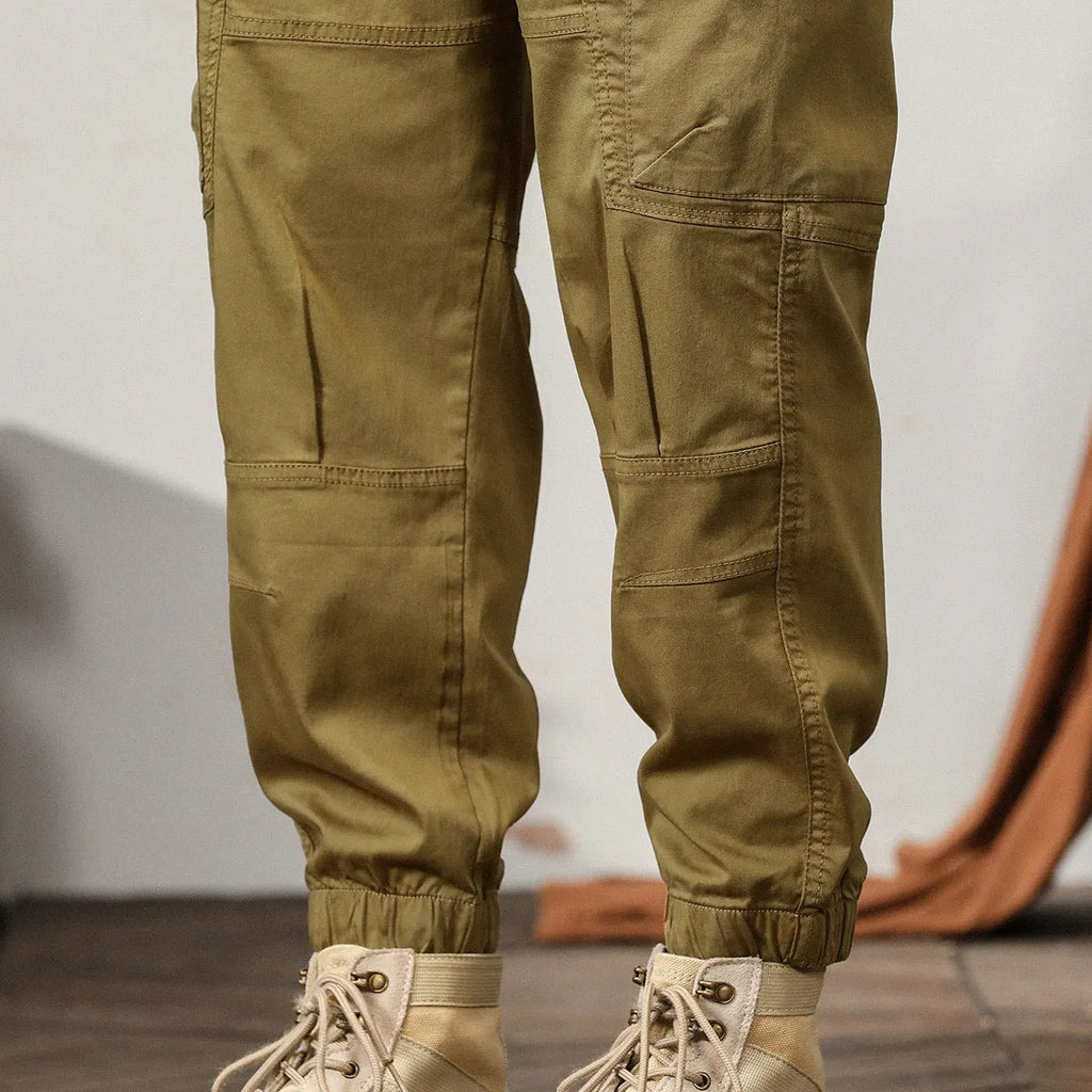 Men's tapered harem pants in cotton fabric showing ankle banded design and small leg opening