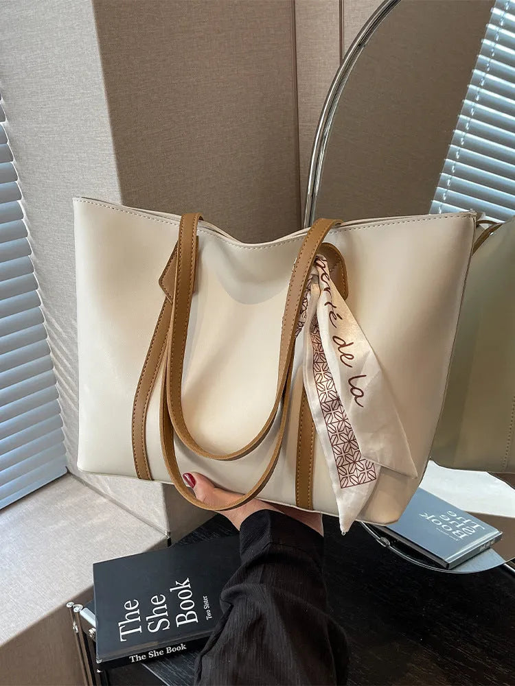 Women's casual tote bag with bucket design showing shoulder strap and crossbody carrying option