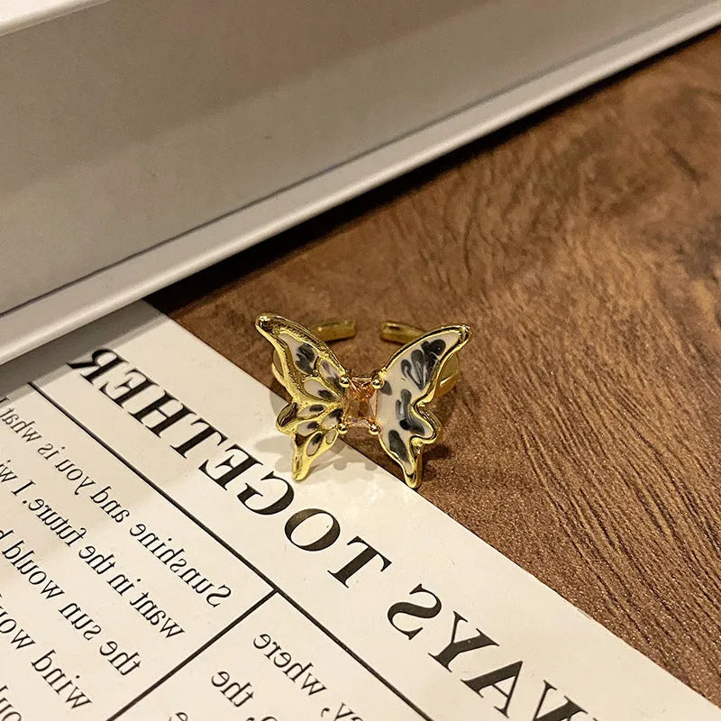 Copper butterfly women's ring with drip oil finish in an open-loop design.