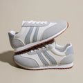 Blue and grey leisure sports shoes with Cortez stripes pattern, round toe, and flat rubber sole.