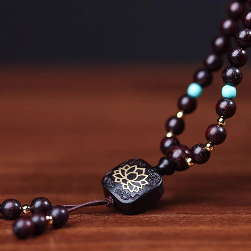 Zambian rosewood bead bracelet with flat lotus pendant showing 108 individual 0.6cm wooden beads