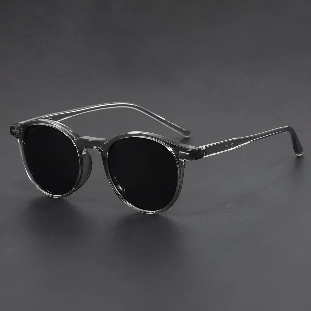 Retro oval round frame sunglasses with grey polarised lenses shown in sand black frame colour.