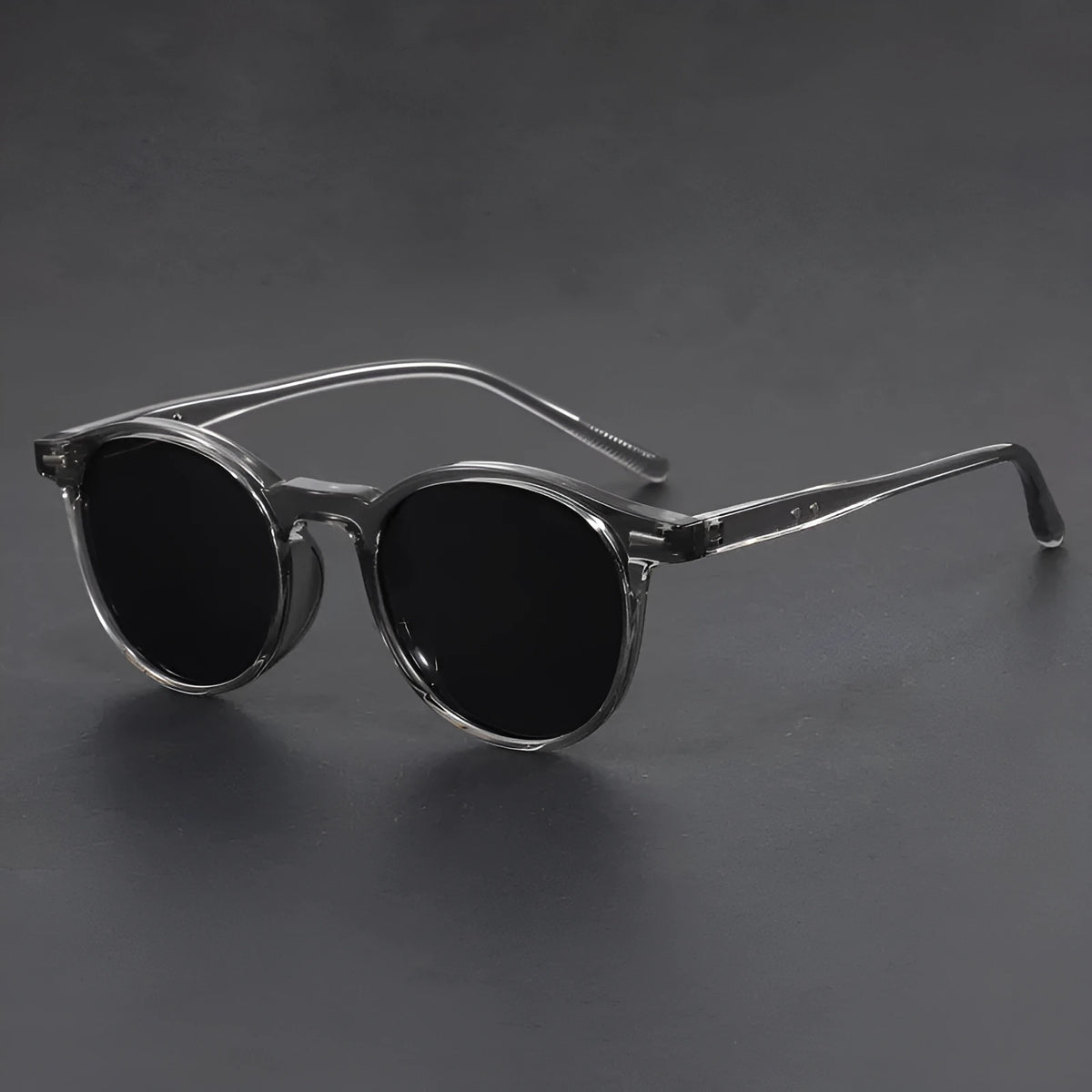Retro oval round frame sunglasses with grey polarised lenses shown in sand black frame colour.