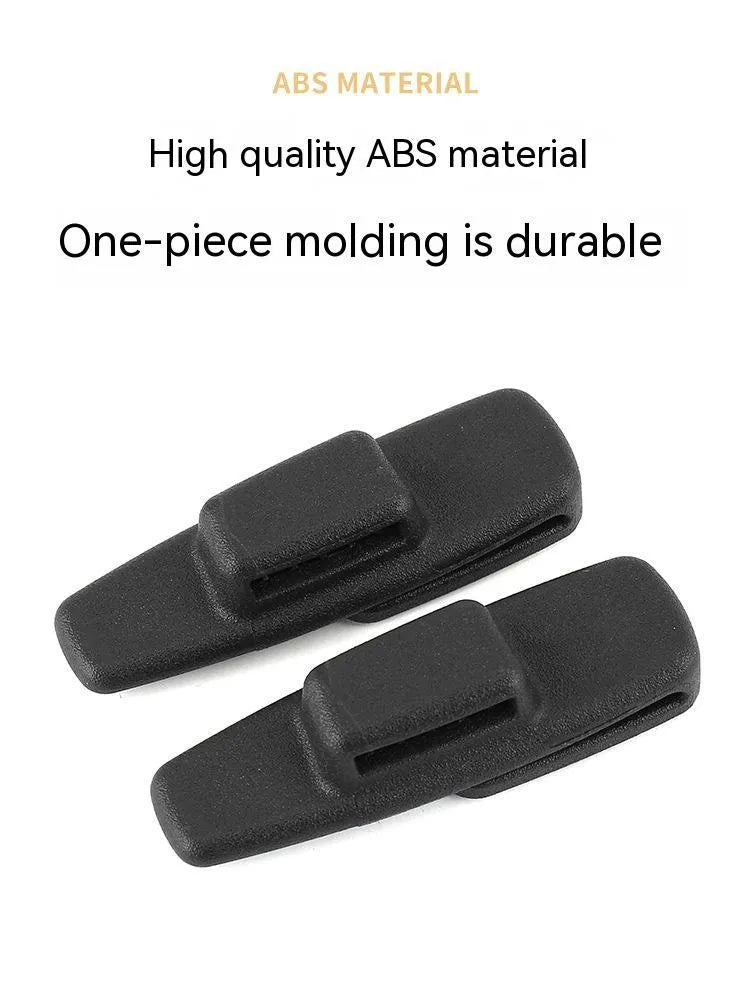Black ABS plastic car seatbelt stopper clip preventing belt retraction