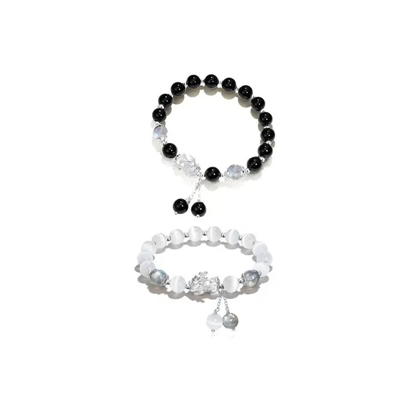 Natural black agate wave-shaped couple bracelet with money painting design on gray background